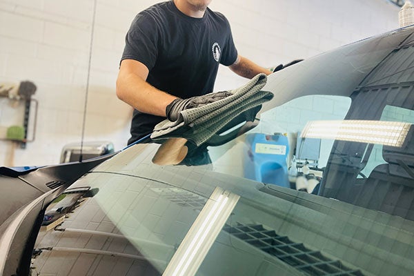 wiping windshield dry